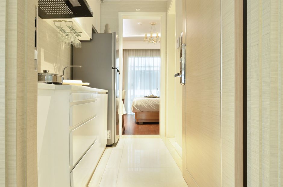 Bright and cozy modern kitchen with a view leading into a stylish bedroom. Perfect blend of functionality and luxury.
