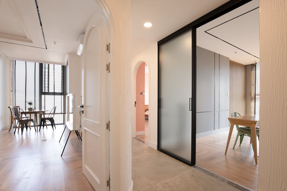 Spacious contemporary apartment interior featuring arched doorways and wooden floors.