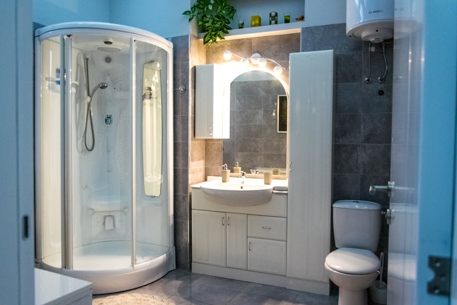 Elegant bathroom design featuring a shower cabin, vanity, and toilet.